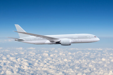 Fototapeta na wymiar Commercial airplane jetliner flying above cumulus clouds in beautiful light. Travel concept.