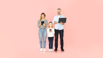 Family Using Smartphone, Laptop And Tablet Browsing Internet, Pink Background