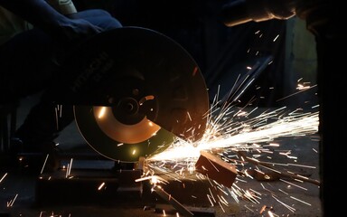 Beautiful view of sparks coming out of the machine when the metal is cut.