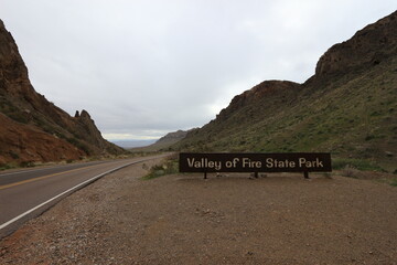 road to the mountains red and yellow mountains and sand in the valley of fire with sign