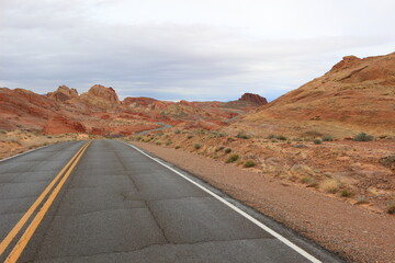 road in the desert red and yellow mountains and sand in the valley of fire