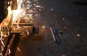 View of sparks coming from cutting metal pipes in an iron workshop.