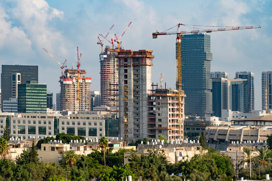 Tel Aviv's skyline high rise construction with cranes and water heaters, Israel. A tall building in a city. High quality photo