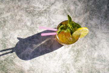 close-up of cocktail glass with zenithal view . Rum or tequila mojito with out-of-focus background.