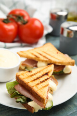 Delicious sandwiches with vegetables, ham and mayonnaise on plate, closeup