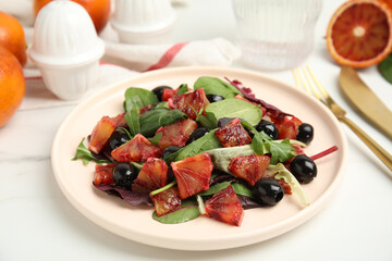 Delicious salad with sicilian orange on white table, closeup