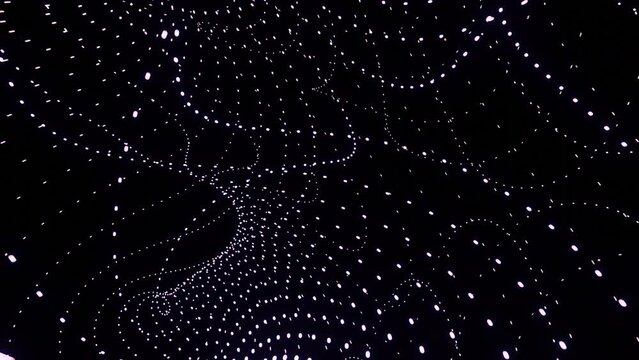 Curved energy flows from points. Design. Point lines move in cosmic stream on black background. Mathematical curved lines of dots move in energy flow