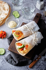 Pita bread with roasted chicken, red bell pepper and cucumber