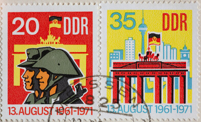 GERMANY, DDR - CIRCA 1971: a postage stamp from GERMANY, DDR, showing DDR soldiers and members of...