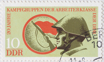GERMANY, DDR - CIRCA 1973: a postage stamp from GERMANY, DDR, showing a member of the civilian...