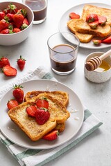 Homemade french cinnamon toast with strawberries, honey and coffee. Morning breakfast, brunch or lunch concept. Selective focus.
