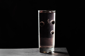 glass of water on black