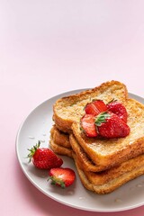 Traditional french toasts with strawberries and honey on pink background. Summer breakfast, brunch or lunch with berries. Copy space. Selective focus.