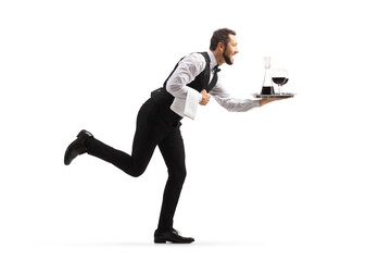 Full length profile shot of a waiter running with wine on a tray