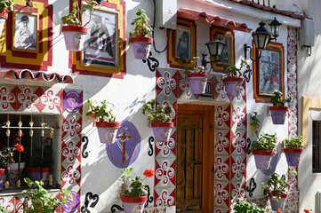 05 May, 2022 - Alicante, Spain: Colored picturesque houses, street. Typical neighborhood historic center, Casco Antiguo, barrio santa cruz. 