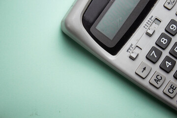 gray big calculator isolated on green background