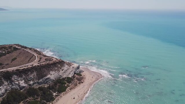 Aerial drone view of the Natural Reserve Foce del Fiume Platani and Capo Bianco in Sicily with turquoise sea and white limestone cliffs on a sunny summer day. Province of Agrigento near Eraclea Minoa.