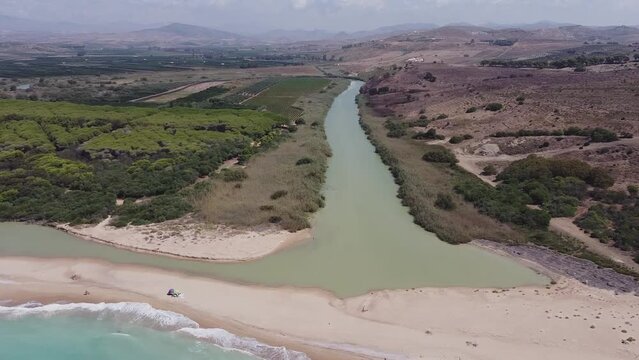 Aerial drone view of the Natural Reserve Foce del Fiume Platani and Capo Bianco in Sicily with turquoise sea and white limestone cliffs on a sunny summer day. Province of Agrigento near Eraclea Minoa.