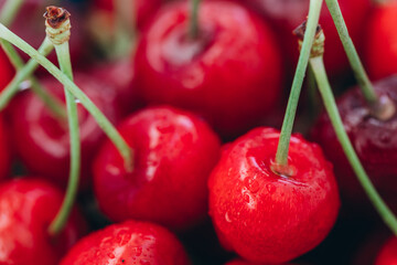Bright juicy red cherry in drops of water.
