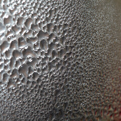 Macro background with water droplets condensation pattern on metal surface 