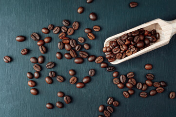 spoon with coffee on a black background.  spoon with coffee beans. coffee bean. Texture  of roasted...