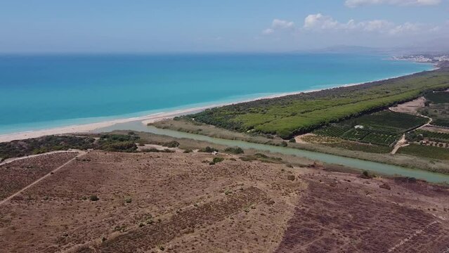 Aerial drone view of the Natural Reserve Foce del Fiume Platani and Capo Bianco in Sicily with turquoise sea and white limestone cliffs on a sunny summer day. Province of Agrigento near Eraclea Minoa.