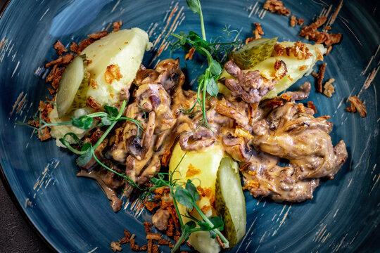 Beef stroganoff, goulash, with sauce and mushrooms, boiled potatoes.
National Russian dish of beef stroganoff with meat, boiled potatoes, mushrooms and fried onions.