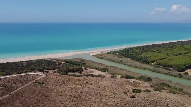 Aerial drone view of the Natural Reserve Foce del Fiume Platani and Capo Bianco in Sicily with turquoise sea and white limestone cliffs on a sunny summer day. Province of Agrigento near Eraclea Minoa.