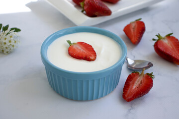 Fresh strawberry yogurt on a light background