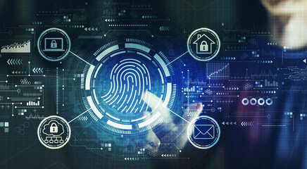 Fingerprint scanning theme with young man touching a digital screen at night