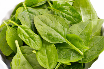 Spinach leaves on white background.