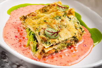 A piece of lasagna on a white plate