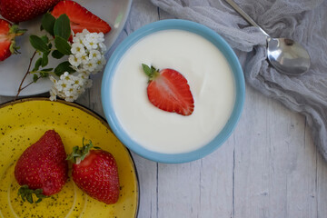 Fresh strawberry yogurt on a light background
