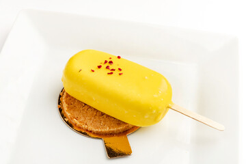 Bitten yellow ice cream bar with lemon taste