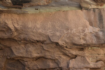 Faded pictographs on a canyon wall