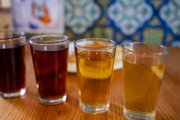 Tasting of different sweet wines from wooden barrels on old bodega in central part of Malaga, Andalusia, Spain
