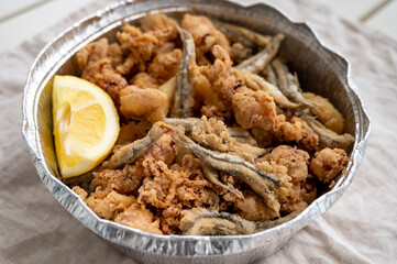 Spanish sea food, cripsy deep fried baby octopus, fish, calamari rings served with lemon