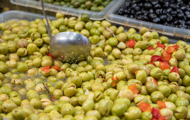Assortment of pickled green olives on farmers market in Malaga, Andalusia, Spain
