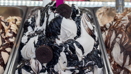 Assortment of colorful artisanal ice cream in refrigerator close up in Spain