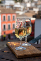 Tasting of Spanish sweet and dry fortified Vino de Jerez sherry wine with view on roofs and houses of old andalusian town