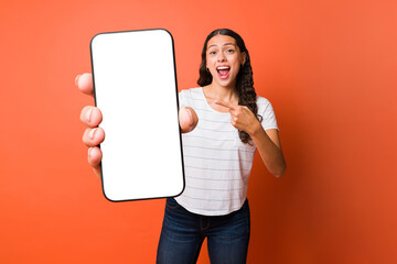 Excited woman showing her text messages and social media