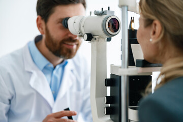 Close-up view of a optometrist checks patient's vision in an optics store or ophthalmology clinic