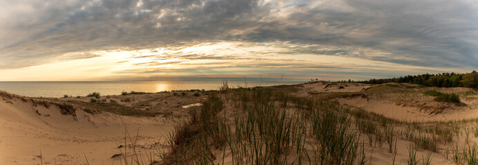 Panoramic view of the grassy sand dunes and Lake Michigan at Sunset