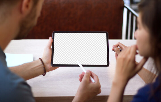 Mockup image of man and woman hands holding and showing black tablet computer with blank white screen template on wooden table.