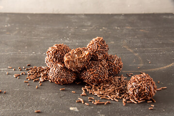 Brigadeiro (Brigadeiro) Traditional Brazilian sweet. Chocolate candies on dark background.