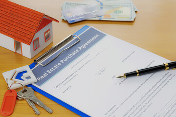 House keys on the rental agreement or the buy home contracts with the real estate property background.