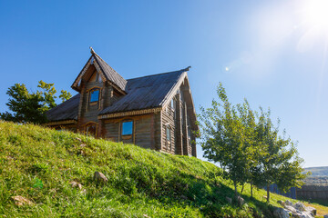 Russian wooden hut against the blue sky. Old village hut. Peasant dwelling.