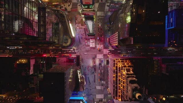 Aerial birds eye overhead top down ascending view of cars driving on streets passing through Times Square. Manhattan, New York City, USA