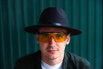 Happy fashion man. Portrait of handsome smiling stylish hipster lambersexual model. Man dressed in...