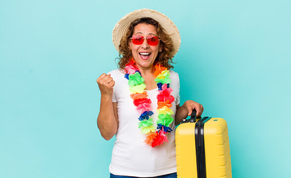 middle age woman feeling shocked,laughing and celebrating success. summer holidays concept